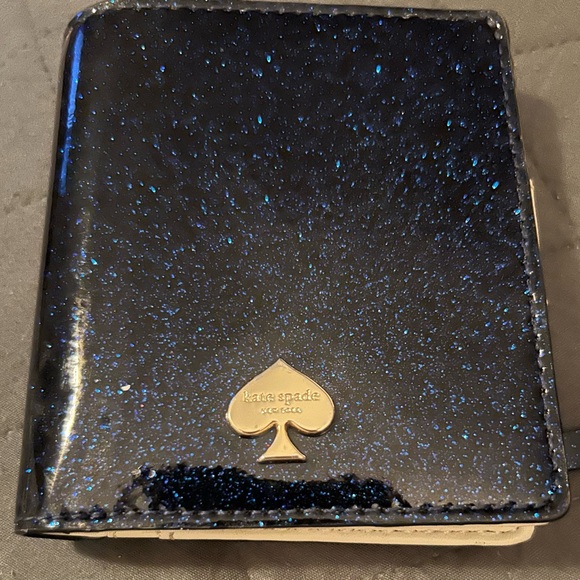 Blue glitter Kate Spade wallet.
3 card slots, ID slot
3.75 x 3.5 inches - Picture 1 of 4